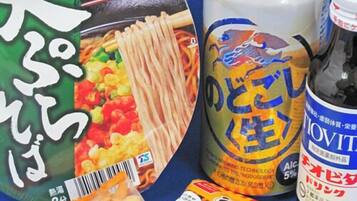 A package of instant noodles, a can of beer, and a bottle of liquor.