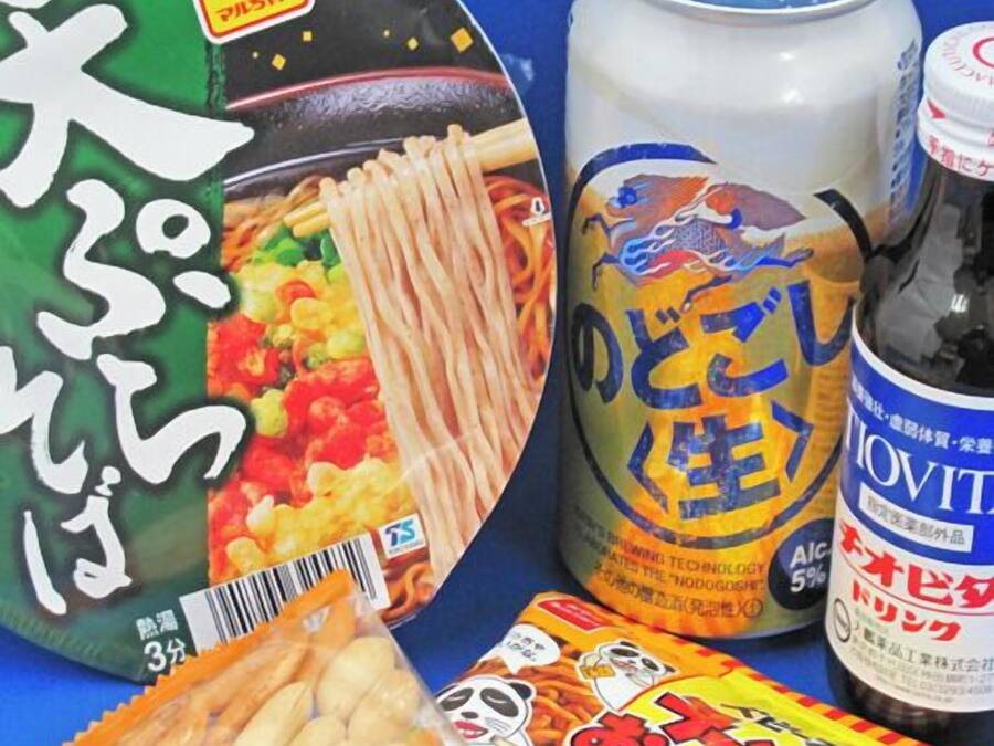 A package of instant noodles, a can of beer, and a bottle of liquor.