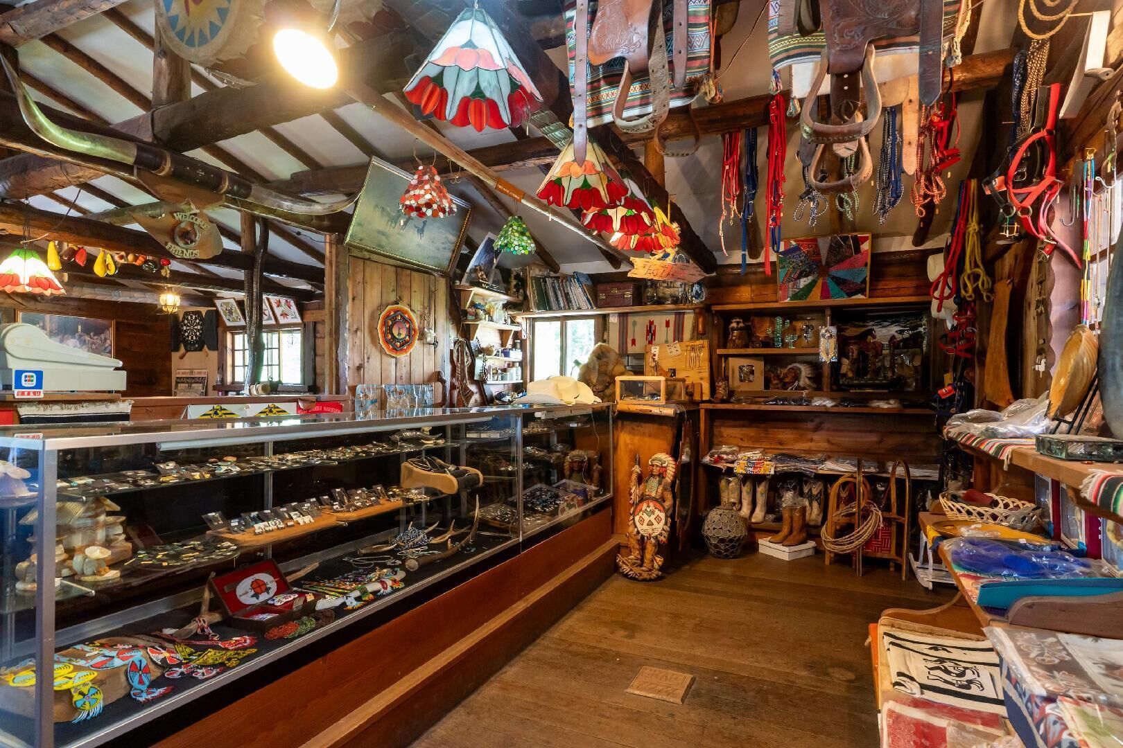 A shop with wooden shelves displaying various items like jewelry, bags, and decorative pieces.