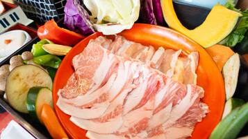 A tray with sliced meat, vegetables, and bread.