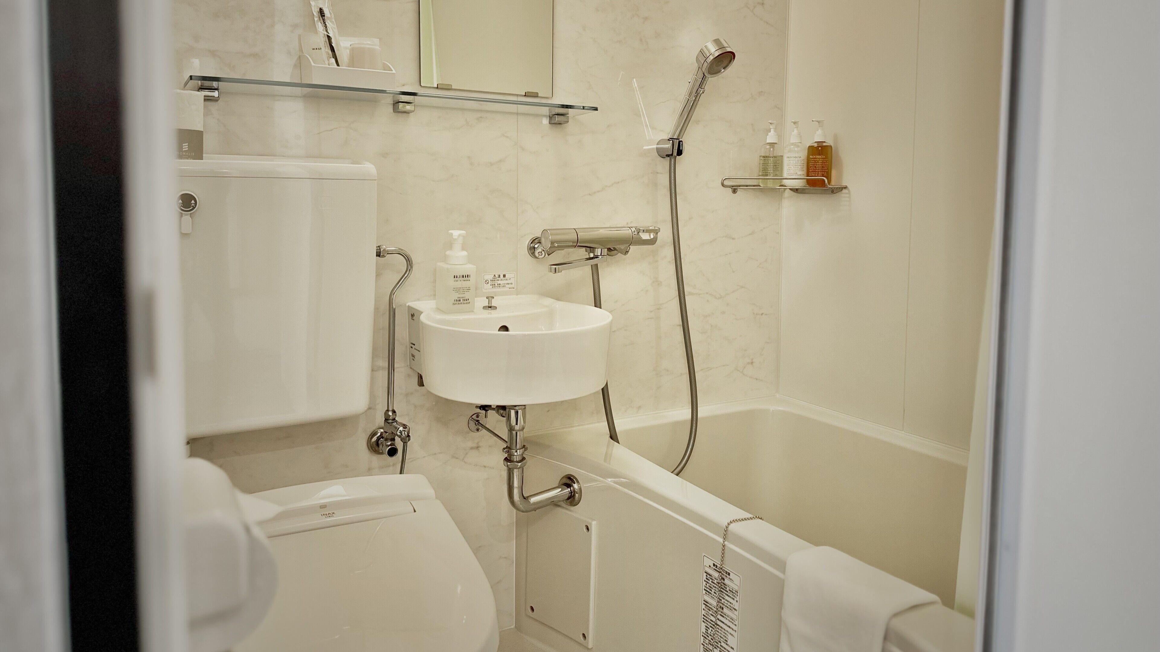 A bathroom with a white sink, a toilet, a bathtub, and a shower.