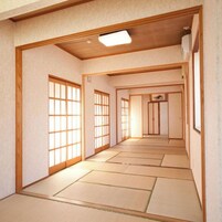 Una habitación tradicional japonesa con suelo de tatami, puertas correderas y una lámpara en el techo.