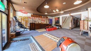 A traditional Japanese room with tatami mats, a bicycle, a drum, and a staircase. - Marue Honkan (Hitoyoshi)