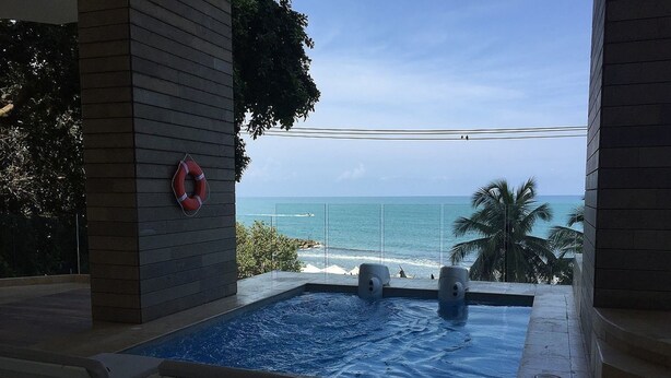An infinity pool with a view of the ocean, a lifebuoy on the wall, and two speakers. - Murano Elite Luxury Bocagrande (Cartagena)