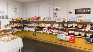 A store with shelves stocked with various packaged goods, including snacks and possibly food items.
