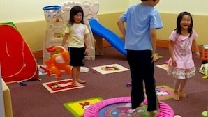 A play area with a slide, a ball pit, and various toys.