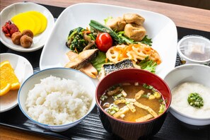 A meal with rice, soup, and various dishes on a tray.