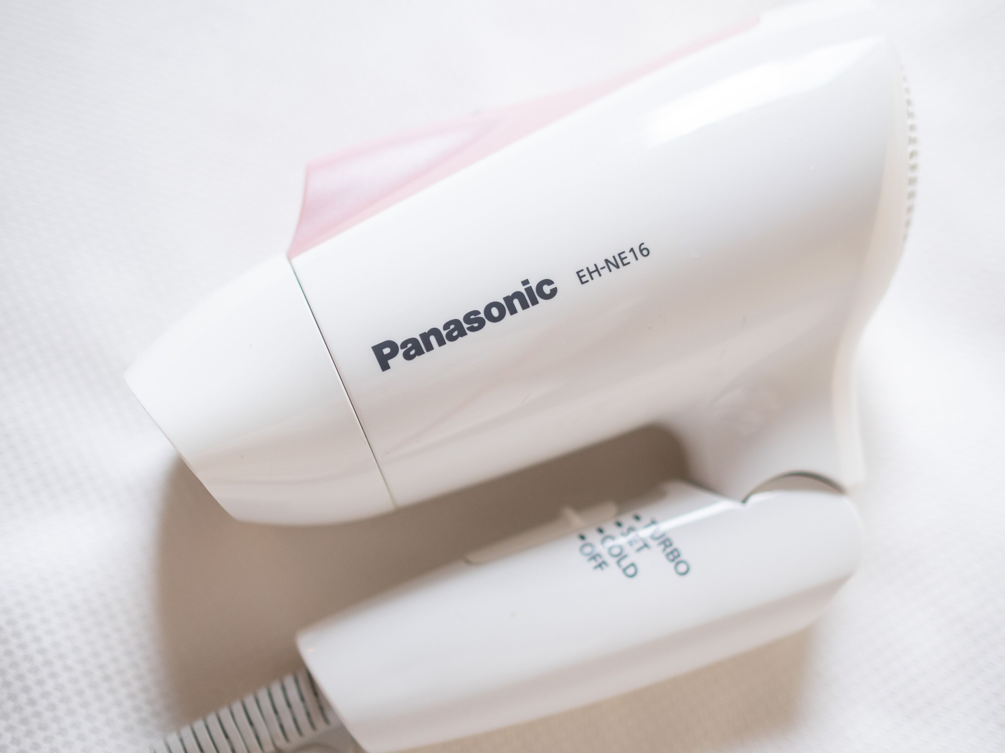 A Panasonic hair dryer with a control panel.