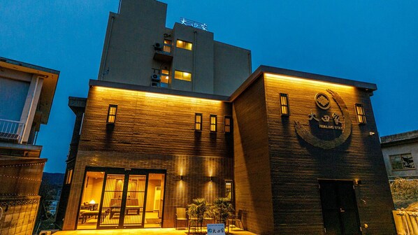 A building with a large sign reading 'Healing Stay' and a logo with a heart and leaf. - Otaya Healing Stay (Toba)