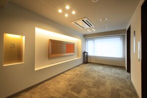 A hallway with a number '3' sign, recessed lighting, a window with blinds, and a door on the right. - Richmond Hotel Nagoya Shinkansenguchi (Nagoya)