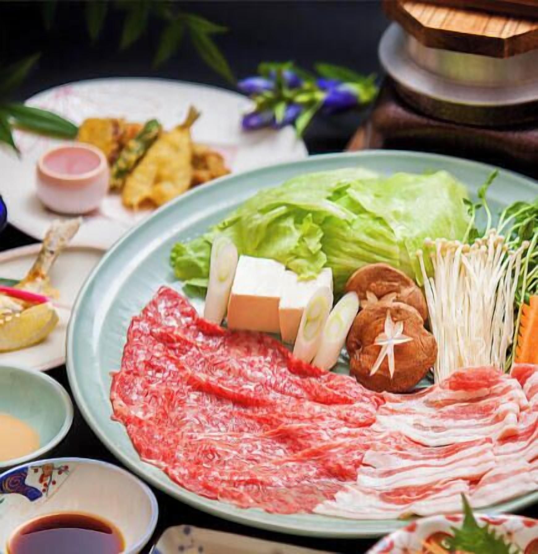 A plate with various food items including meat, vegetables, and condiments.