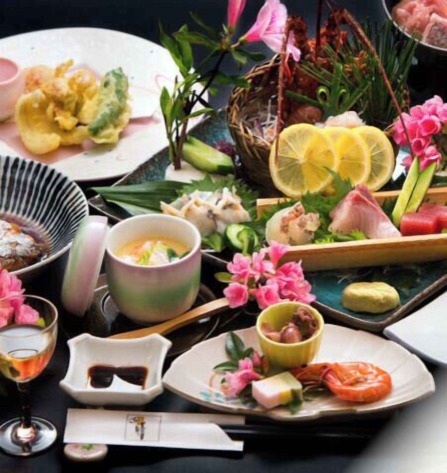 A table with various dishes, a drink, and a small decorative item.