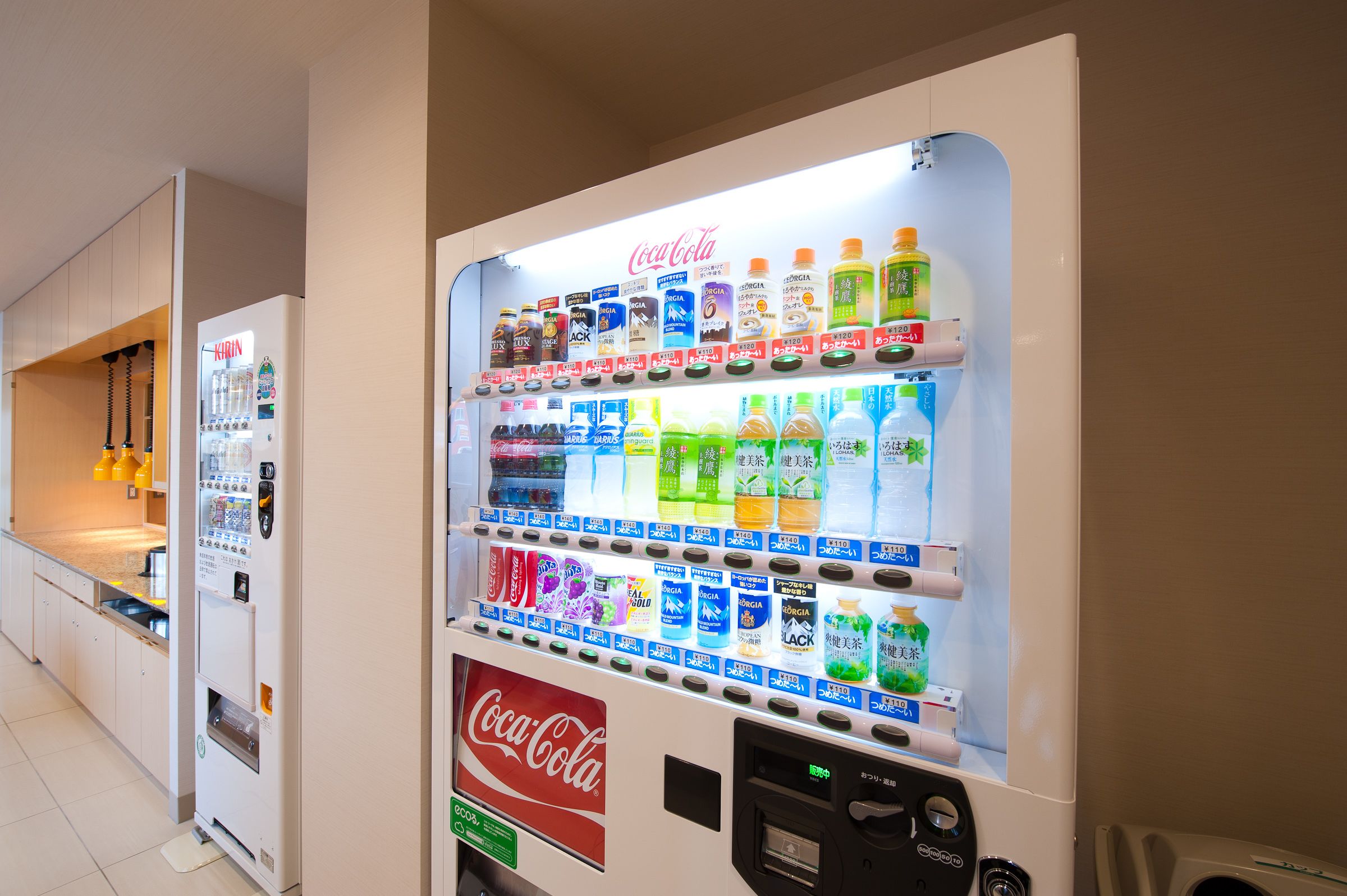 A vending machine with various beverage options including Coca-Cola, Kirin, and other brands.