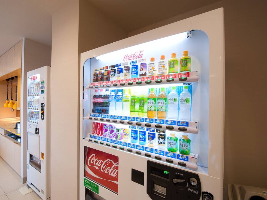 A vending machine with various beverage options including Coca-Cola, Kirin, and other brands.
