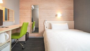 A hotel room with a bed, a desk with a chair, a mirror, a wall-mounted light, and a thermostat. - Super Hotel Kofu Showa Inter (Showa)