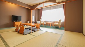 A room with tatami flooring, a television, a dining table with chairs, and a large window with curtains. - Ooedo Onsen Monogatari Kimitsu no Mori (Kimitsu)