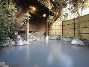 A traditional Japanese onsen with a wooden structure, a bamboo fence, and a stone-lined pool. - Kurokawa Onsen Wafu Ryokan Misato (Minamioguni)