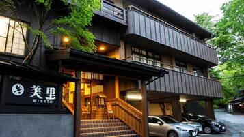 A multi-story building with a sign reading 'MISATO' and a staircase leading to the entrance.