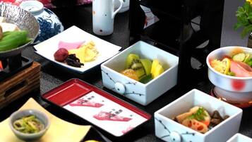 A variety of food items and dishes arranged on a table with a floral background.