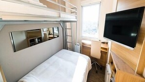 A compact hotel room with bunk beds, a desk, a chair, a television, and a window. - Sekishuu no Yu Super Hotel Gotsu Ekimae (Gotsu)