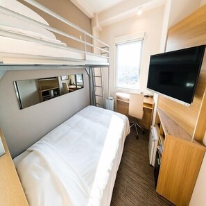 A compact hotel room with bunk beds, a desk, a chair, a television, and a window. - Sekishuu no Yu Super Hotel Gotsu Ekimae (Gotsu)