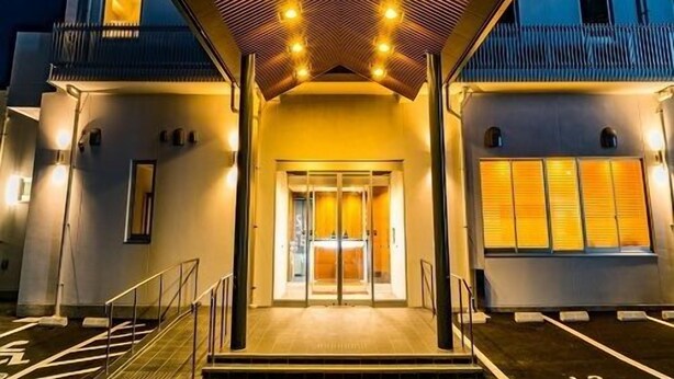 A hotel entrance with a modern design, featuring a geometric roof structure and a glass door entrance. - Sekishuu no Yu Super Hotel Gotsu Ekimae (Gotsu)