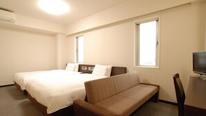 A hotel room with a large bed, a sofa, a TV, and two windows. - AB Hotel Toyota Motomachi (Toyota)