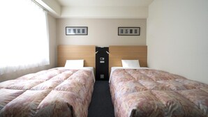 A hotel room with two beds, a wooden headboard, a small door, and two framed pictures on the wall. - Hotel Econo Taki (Taki)