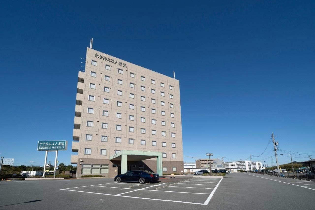 A multi-story hotel building with a sign indicating it is the Greens Hotels.