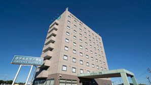 A multi-story hotel building with a sign indicating it is the Greens Hotel. - Hotel Econo Taki (Taki)