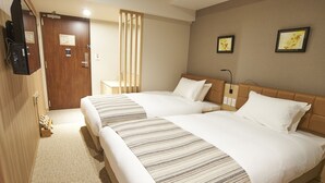 A hotel room with two beds, a wooden wardrobe, a desk, and a wall-mounted TV. - Quintessa Hotel Tokyo Haneda Comic & Books (Tokyo)