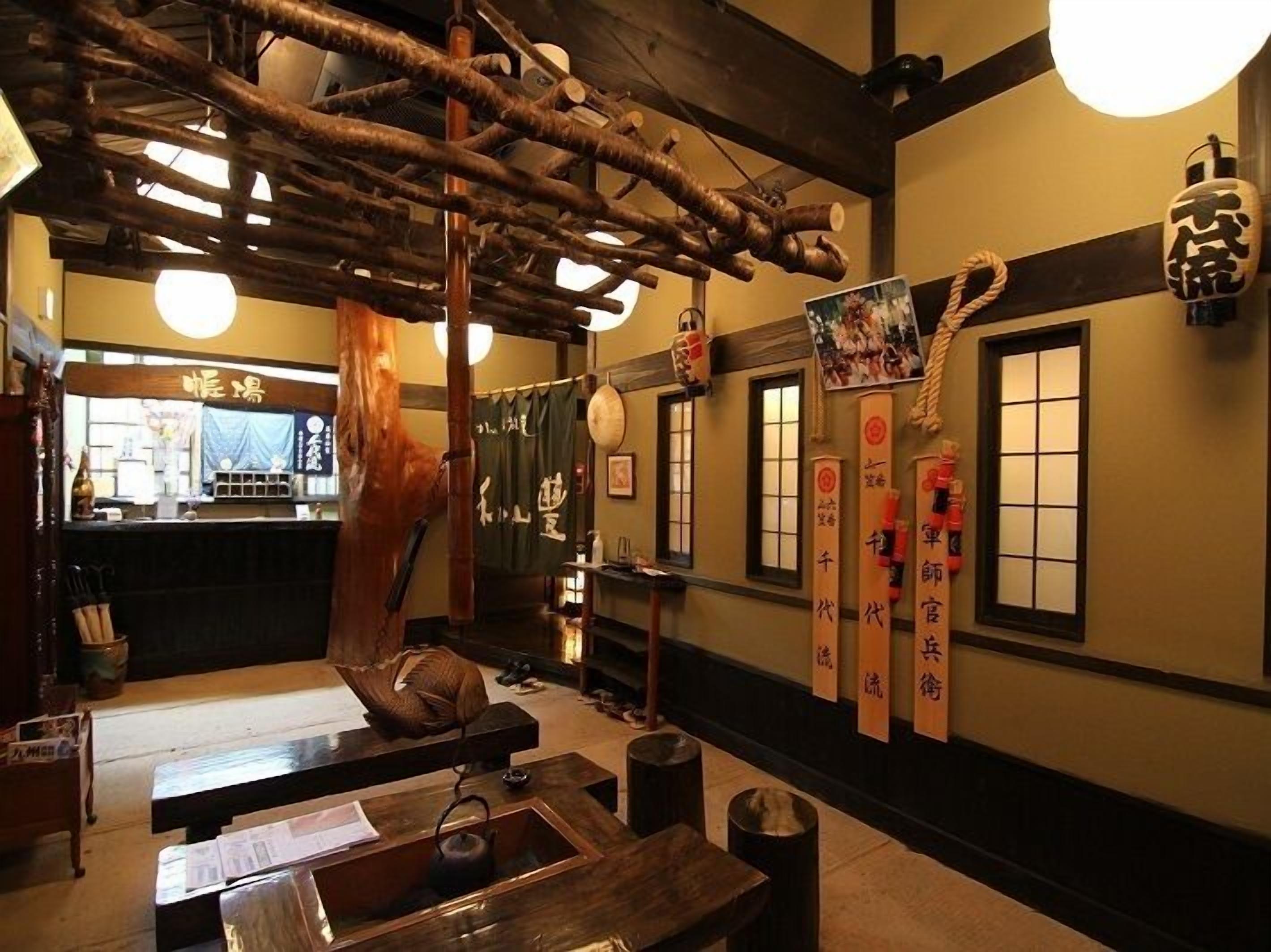 A traditional Japanese interior with wooden beams, tatami flooring, and shoji screens.