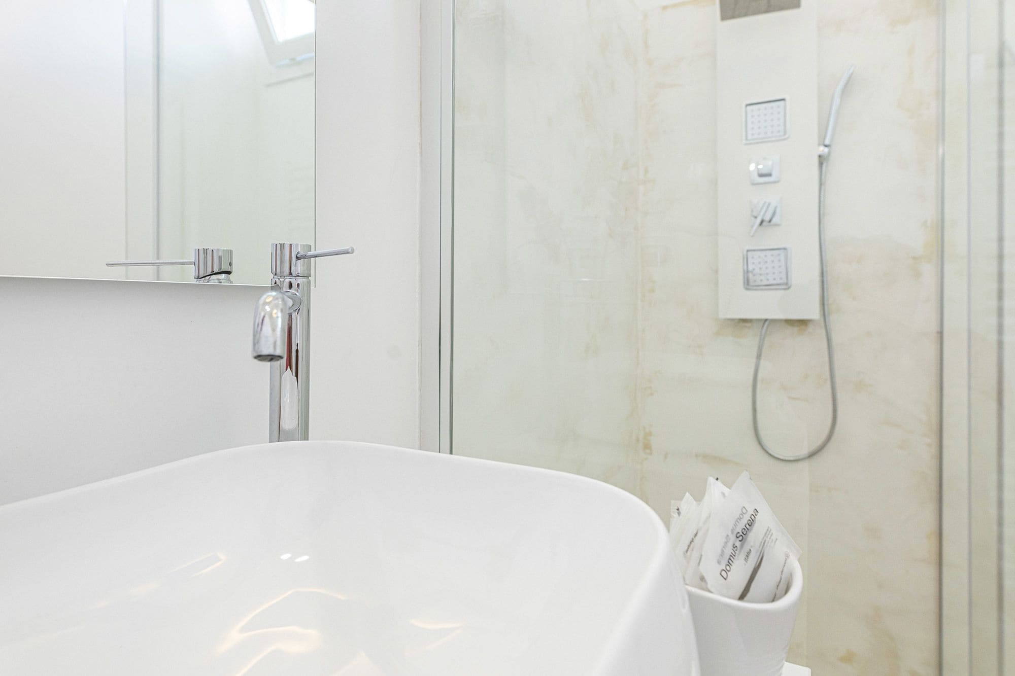 A modern bathroom with a freestanding bathtub, a glass shower enclosure, and a towel rack.