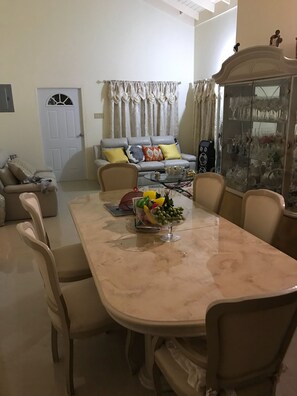 Relax and socialize in this stylish living room with a sofa, coffee table, and dining area.