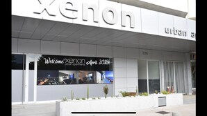 A modern building with the name "Xenon" prominently displayed. - Xenon urban apartments (Maputo)