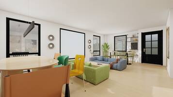 Ein modernes Wohnzimmer mit Essbereich, einer Sofagarnitur und einem Couchtisch.
