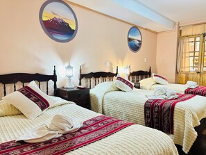 A hotel room with two beds, a nightstand with a lamp, and two wall-mounted paintings. - La Posada de la Abuela Obdulia (La Paz)