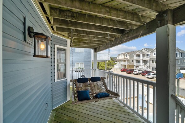 Relax on the covered porch with a swing seat, perfect for taking in the surroundings.