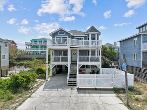 Stunning two-story home with a central entrance and a spacious balcony.
