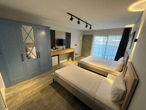 A bedroom with a bed, a desk, a wardrobe, a television, and a window with curtains. - Duman Boutique Hotel (Cesme)