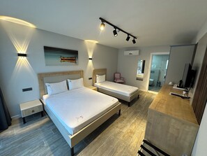 A modern hotel room with two beds, a small desk, a chair, and a mirror. - Duman Boutique Hotel (Cesme)