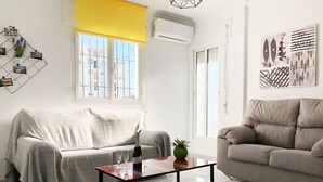 A living room with two sofas, a coffee table, and a wall-mounted photo display. - 1028 Casa Evelyn D (Nerja)