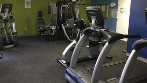 A gym with treadmills, weight machines, and a wall clock. - Ocean View Unit North Myrtle Beach!  May 5- May 12, 2019 (North Myrtle Beach)