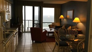 A hotel room with a kitchen, dining area, and a balcony with a view. - Ocean View Unit North Myrtle Beach!  May 5- May 12, 2019 (North Myrtle Beach)