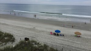 A beach with umbrellas and beach chairs, a sandy shore, and the ocean in the background. - Ocean View Unit North Myrtle Beach!  May 5- May 12, 2019 (North Myrtle Beach)
