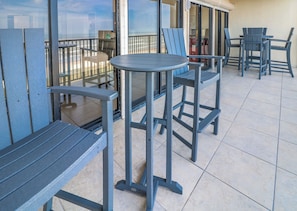 Relax on the balcony with a round table and four comfortable chairs.