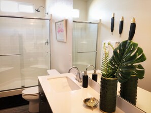 Bathtub, hair dryer, towels, toilet paper