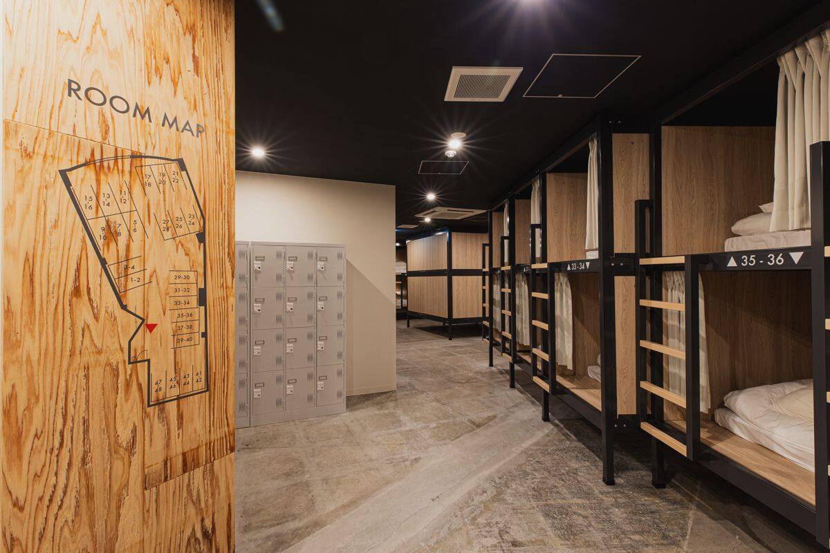 A room with bunk beds, a room map, and lockers.