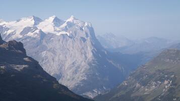 A mountainous landscape with snow-capped peaks and a valley.