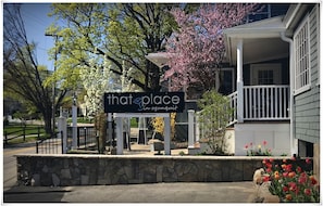 Welcome to that place in Ogden, featuring a charming stone entrance, a cozy porch with a white railing, and a beautiful balcony overlooking the surrounding area.